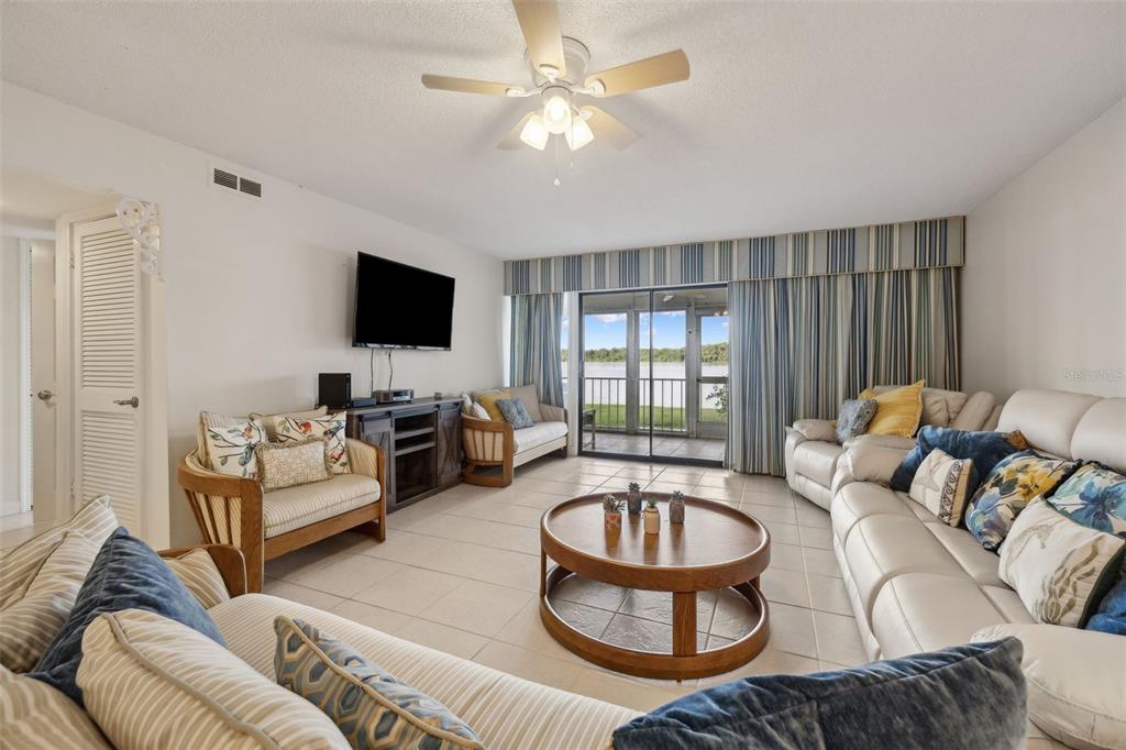 125 River Bend Road, Unit D Welaka, FL 32193 - Photo 16 of 53 a living room with furniture and a flat screen tv