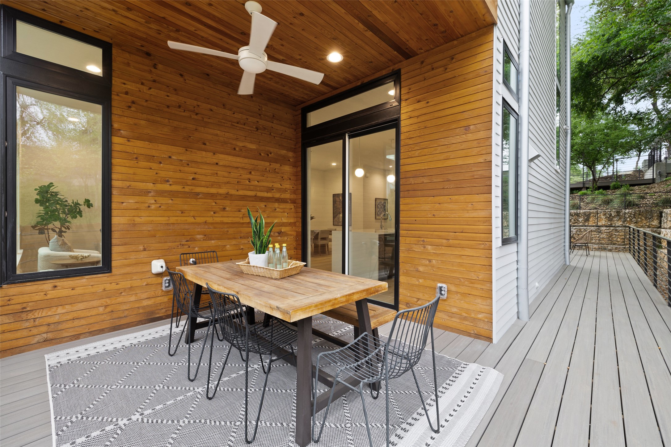 900 South 2nd Street, Unit 20 Austin, TX 78704 - Photo 32 of 40 a view of a patio with table and chairs with wooden floor and fence