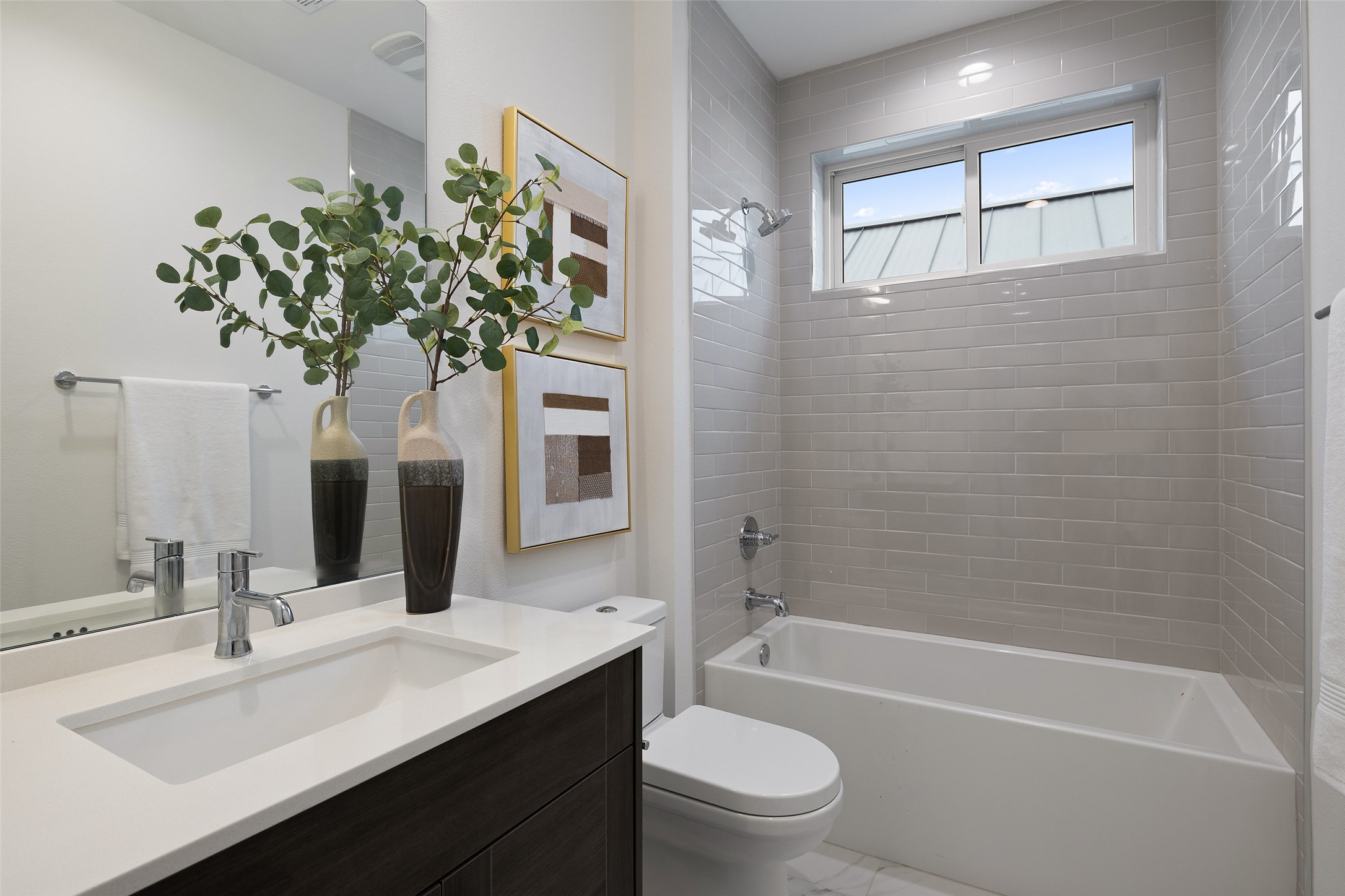 900 South 2nd Street, Unit 20 Austin, TX 78704 - Photo 34 of 40 a bathroom with a sink a toilet a mirror a vanity a bathtub and shower