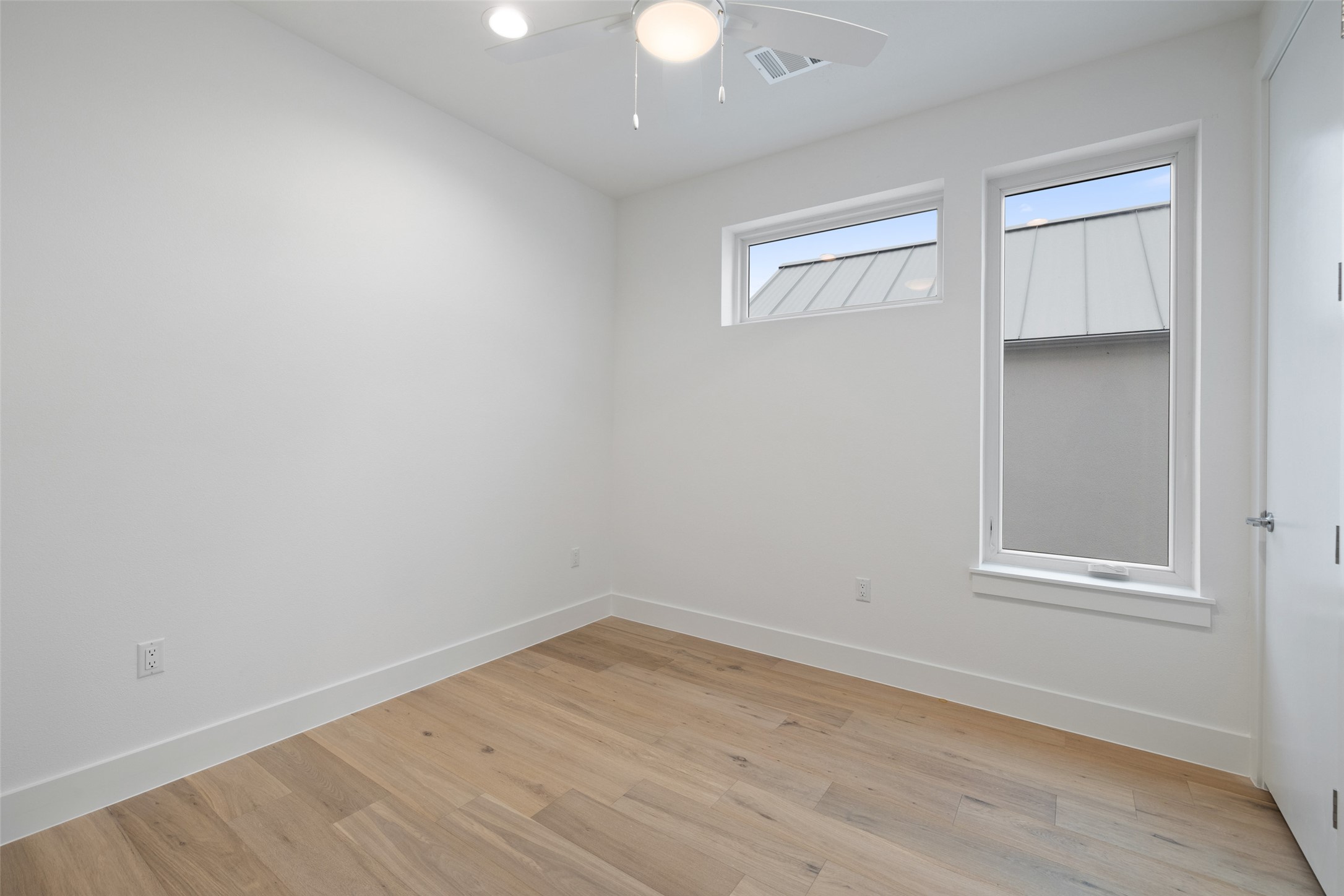 900 South 2nd Street, Unit 20 Austin, TX 78704 - Photo 35 of 40 wooden floor in an empty room with a window
