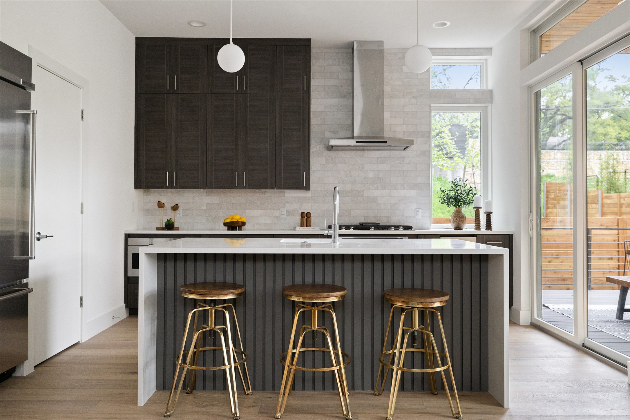 900 South 2nd Street, Unit 20 Austin, TX 78704 - Photo 4 of 40 a kitchen with a sink chairs and wooden cabinets