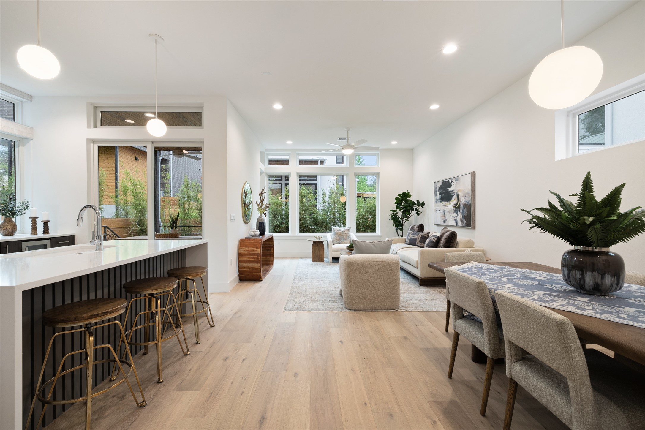 900 South 2nd Street, Unit 20 Austin, TX 78704 - Photo 9 of 40 a living room with kitchen island furniture a chandelier a sink and a large mirror