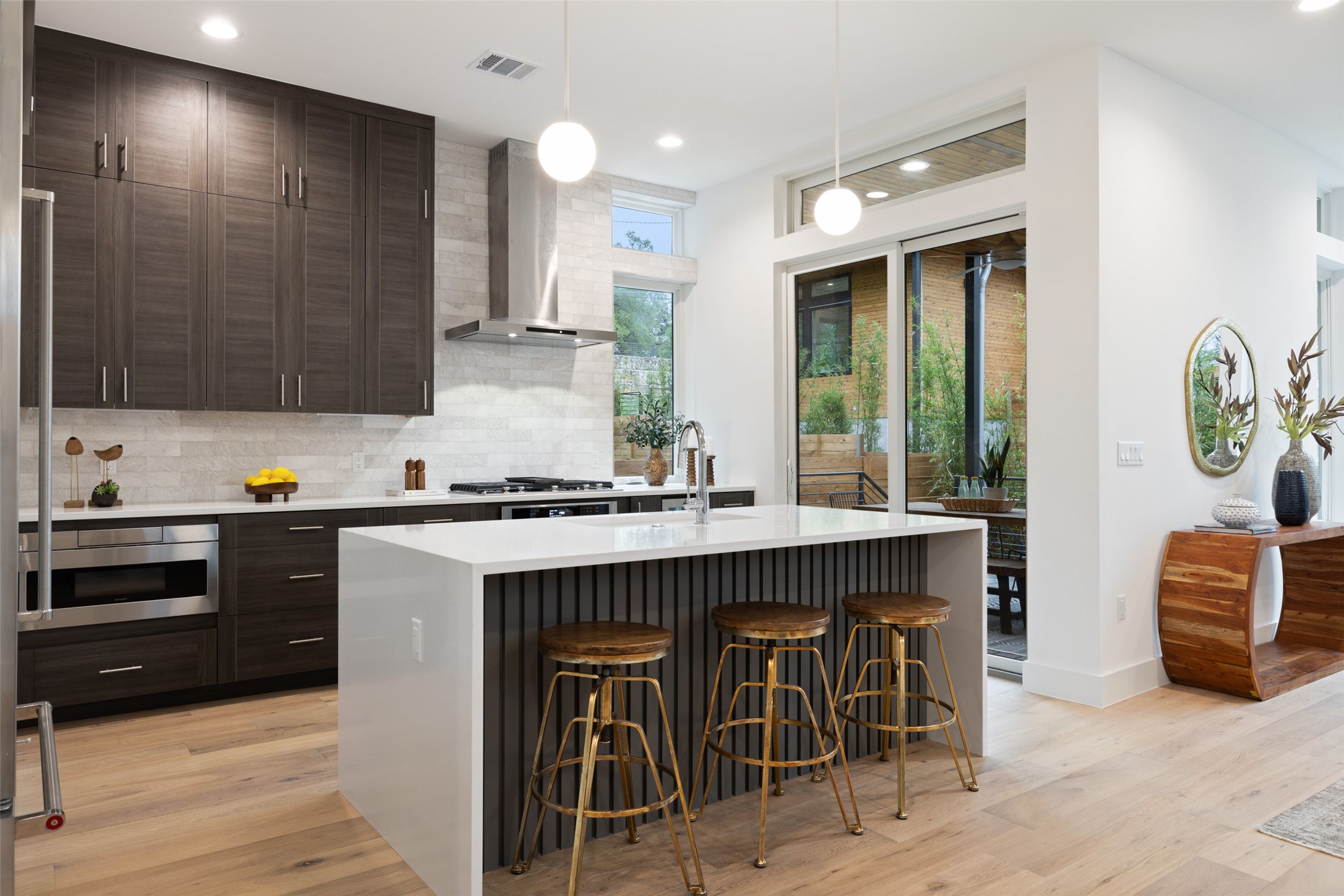 900 South 2nd Street, Unit 20 Austin, TX 78704 - Photo 10 of 40 a kitchen with stainless steel appliances granite countertop a stove a sink and a microwave