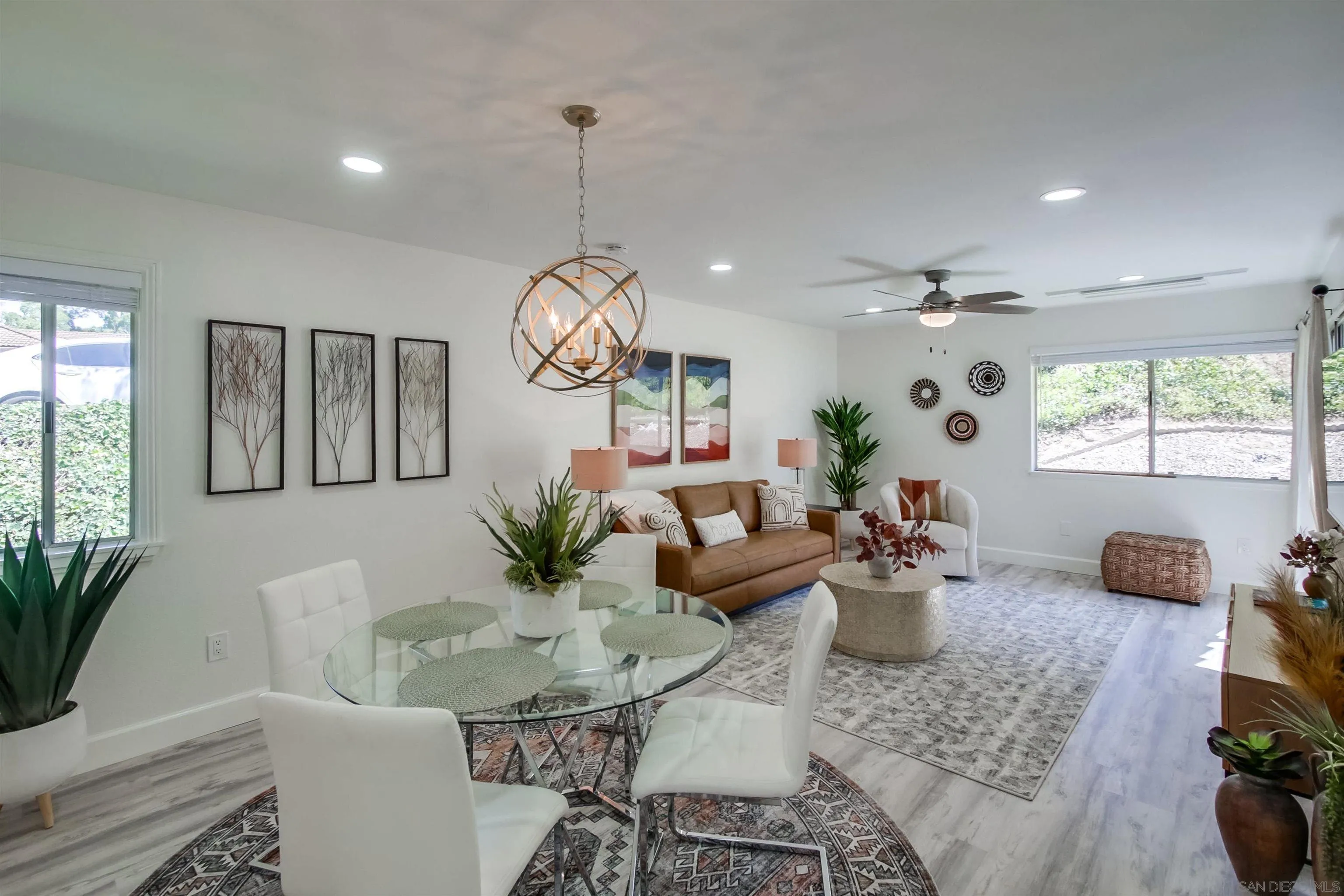 a living room with furniture potted plant and a window