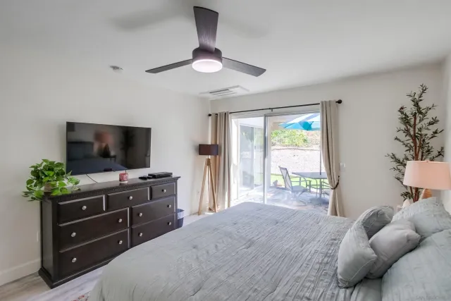 a bedroom with a bed and a flat screen tv