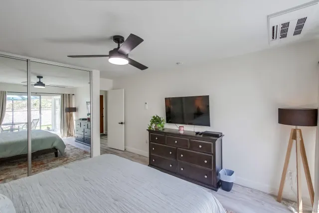 a bedroom with a bed and flat screen tv