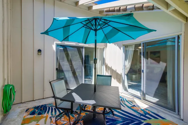 a view of balcony with furniture and umbrella