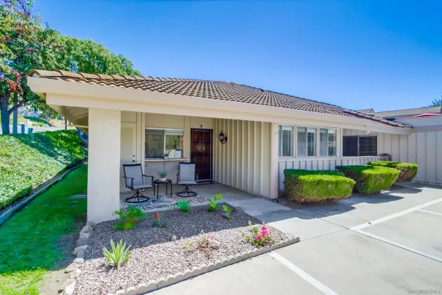 a front view of a house with garden and porch