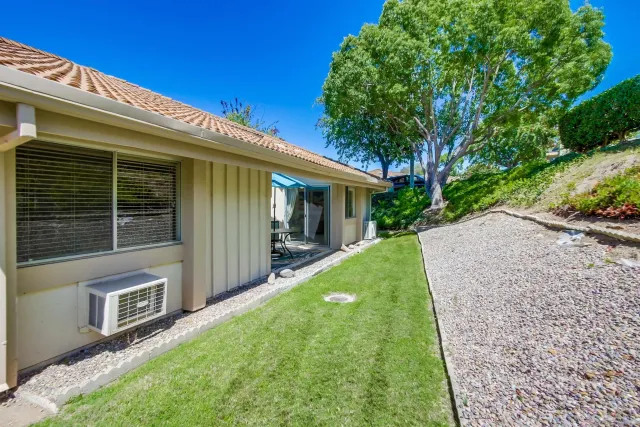 a view of a house with backyard and porch