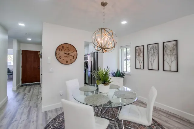 a view of a dining room with furniture wooden floor and a clock