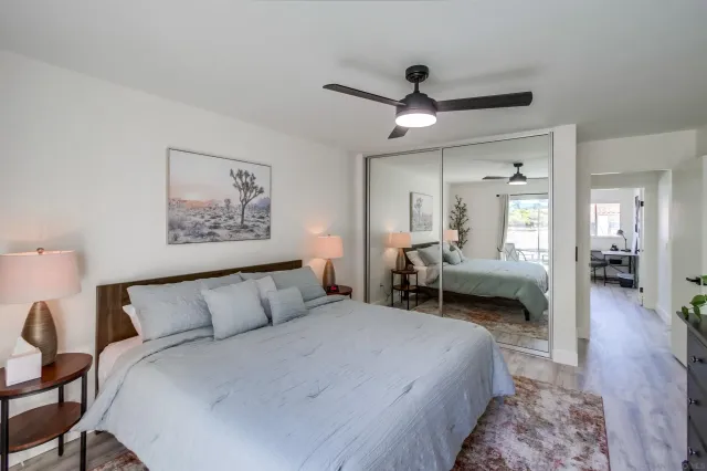 a bedroom with a large bed and a mirror