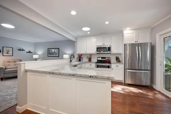 a kitchen with a refrigerator and a stove top oven