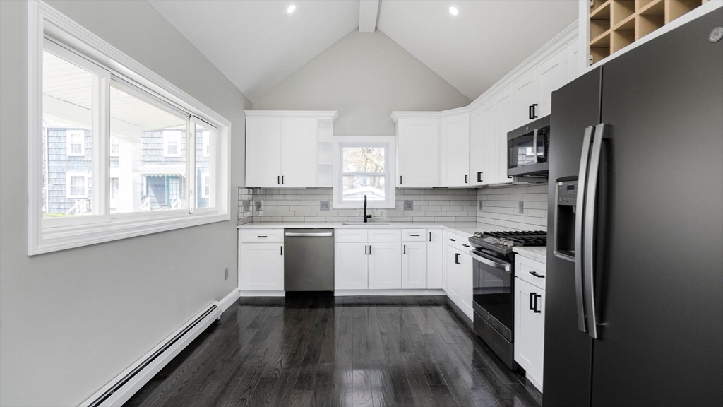 a kitchen with stainless steel appliances a stove a sink and a refrigerator