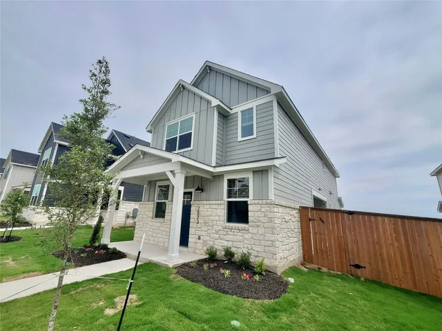 a front view of a house with a garden and plants