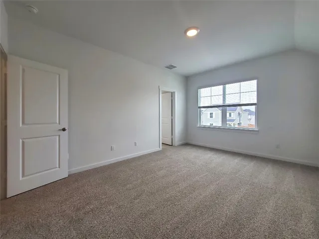 an empty room with windows and closet in a room