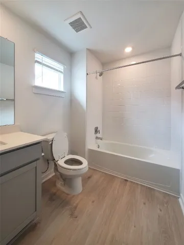 a bathroom with a toilet a sink and bathtub