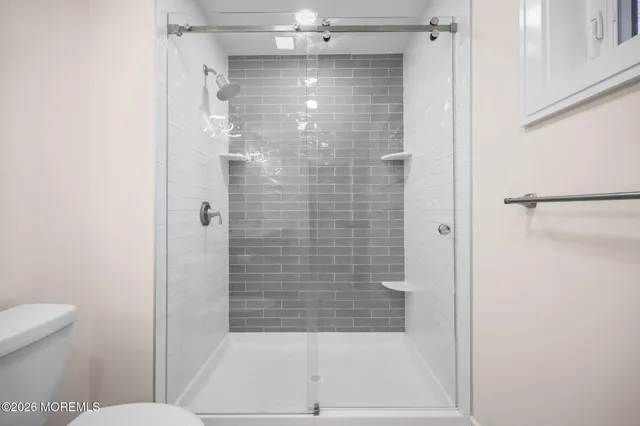 a bathroom with a glass shower door