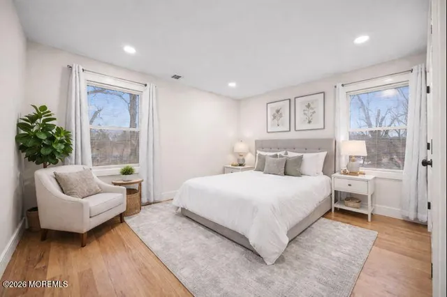 a spacious bedroom with a bed and a couch