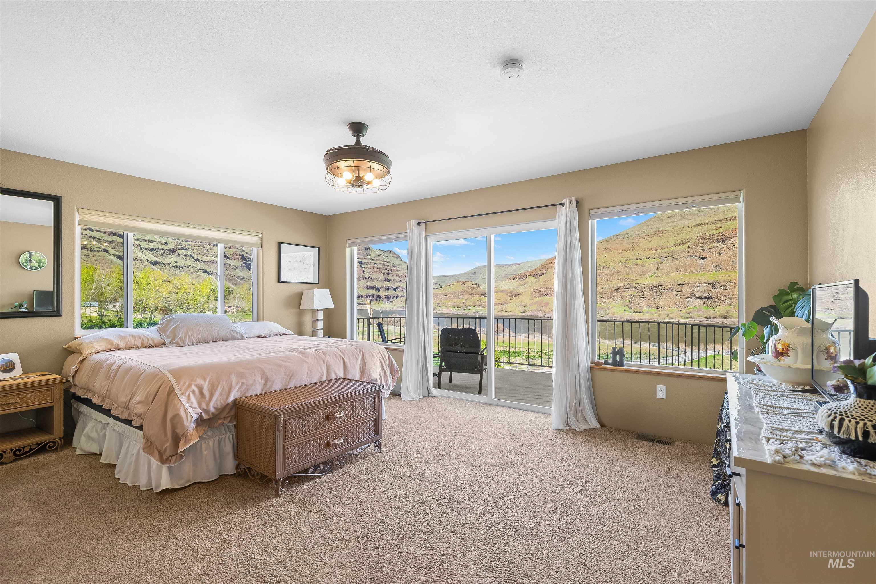 11056 Snake River Road Asotin, WA 99402 - Photo 22 of 50 Bedroom with access to exterior and light colored carpet