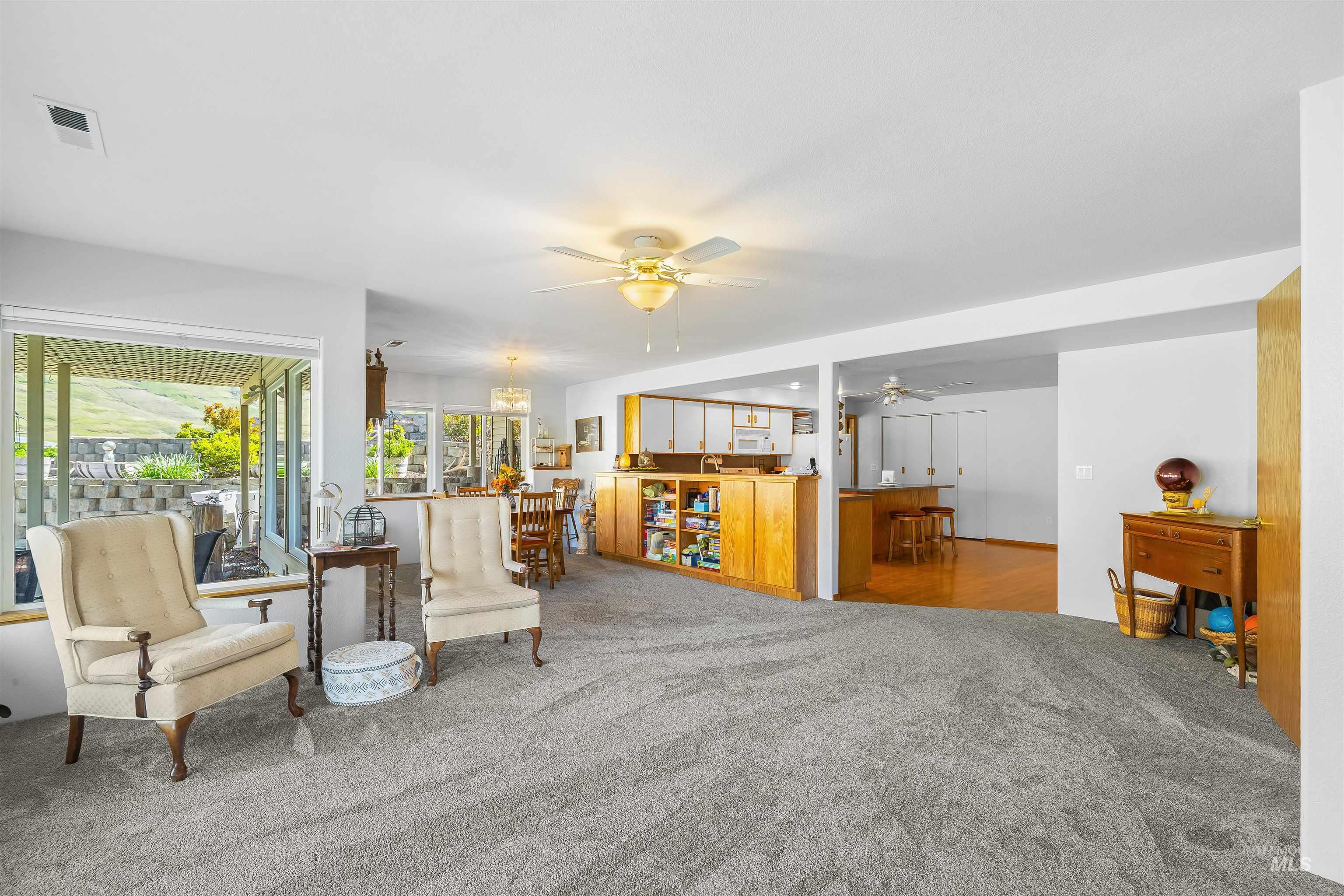 11056 Snake River Road Asotin, WA 99402 - Photo 26 of 50 Living area with carpet floors and a ceiling fan
