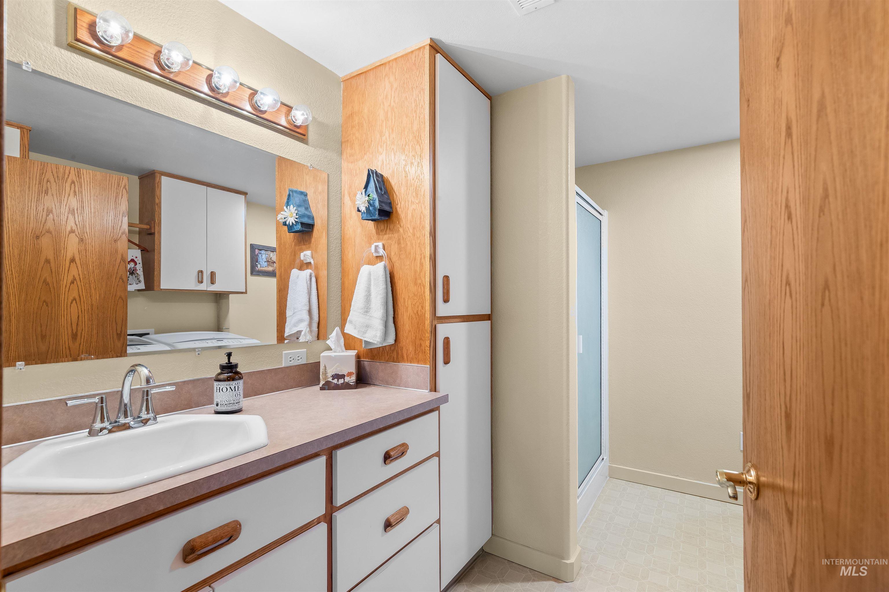 11056 Snake River Road Asotin, WA 99402 - Photo 29 of 50 Bathroom with vanity, a stall shower, and light floors