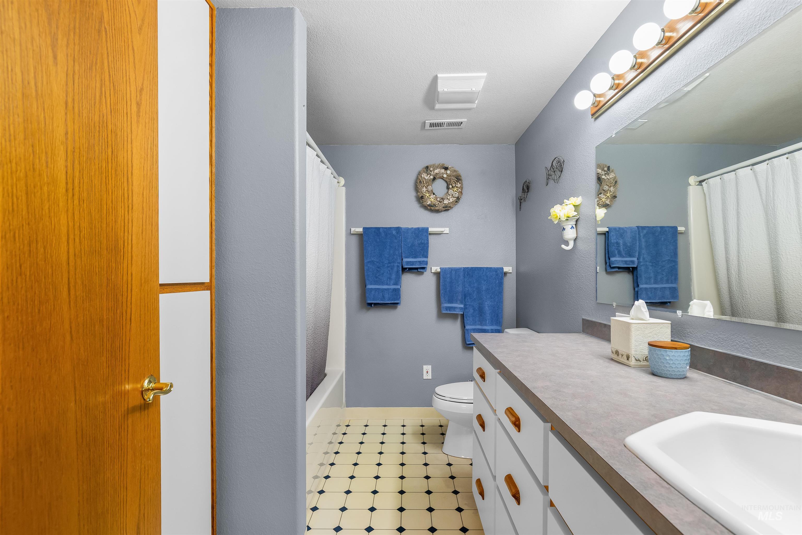 11056 Snake River Road Asotin, WA 99402 - Photo 32 of 50 Full bathroom with vanity, shower / bath combo with shower curtain, and light floors