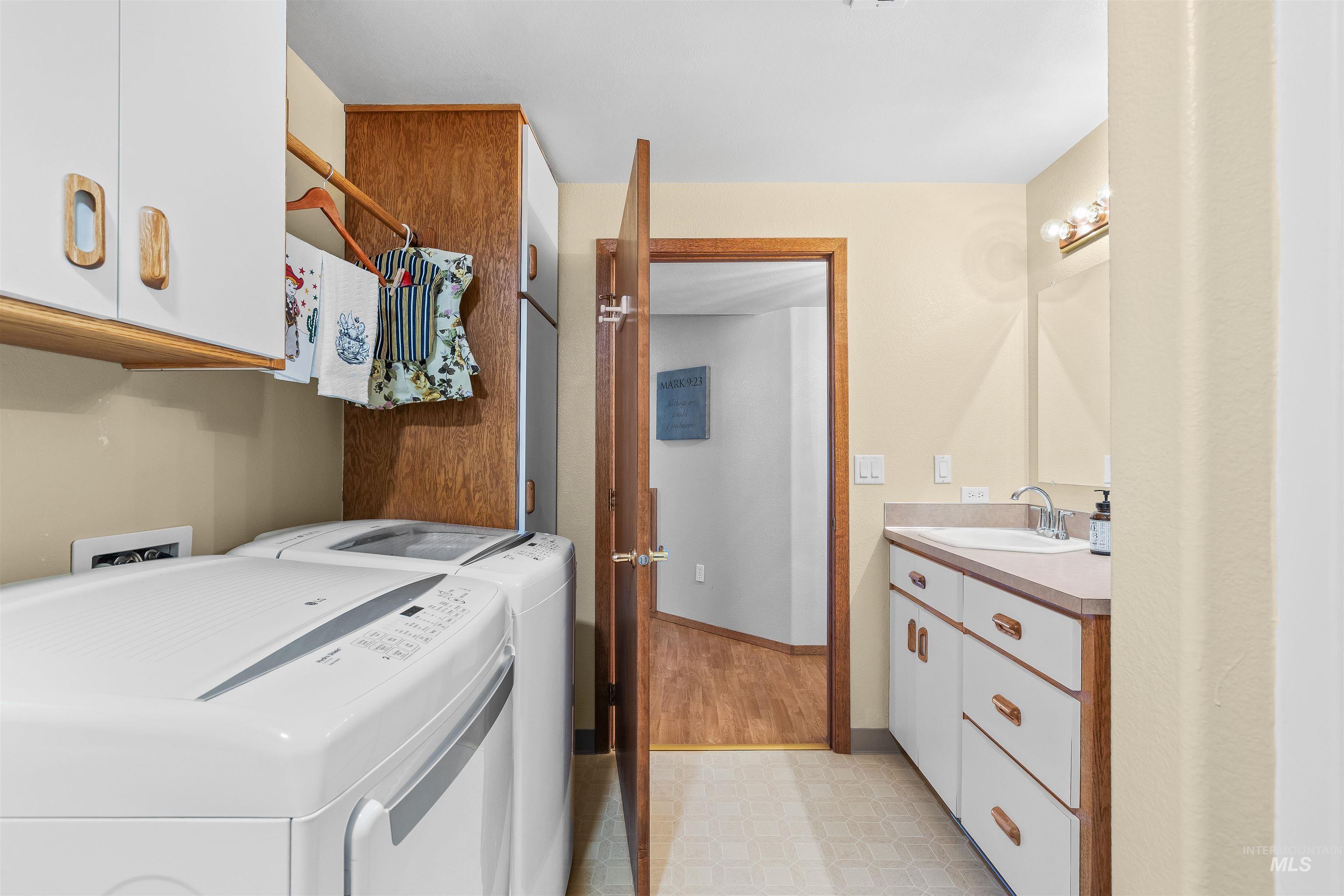 11056 Snake River Road Asotin, WA 99402 - Photo 33 of 50 Laundry area featuring light floors, independent washer and dryer, and cabinet space