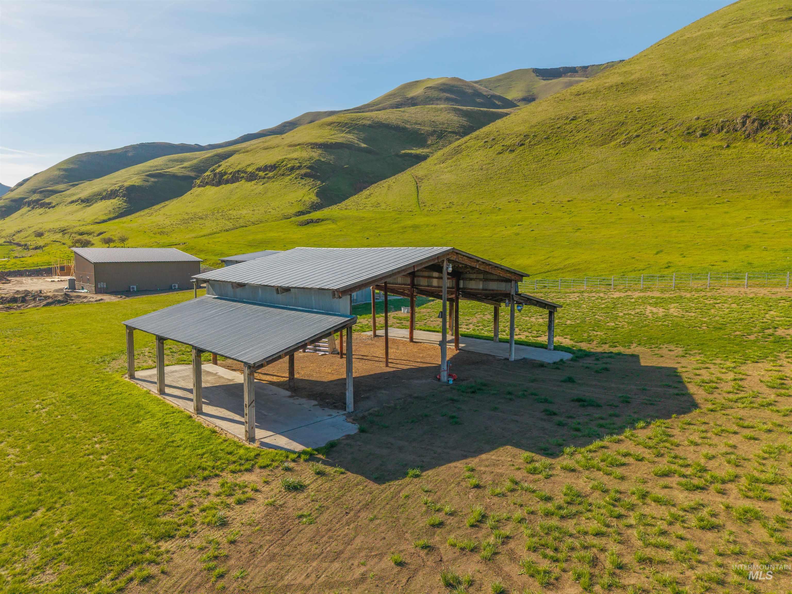 11056 Snake River Road Asotin, WA 99402 - Photo 46 of 50 View of property's community featuring an outdoor structure, a view of rural / pastoral area, a mountain view, a detached carport, and a patio area