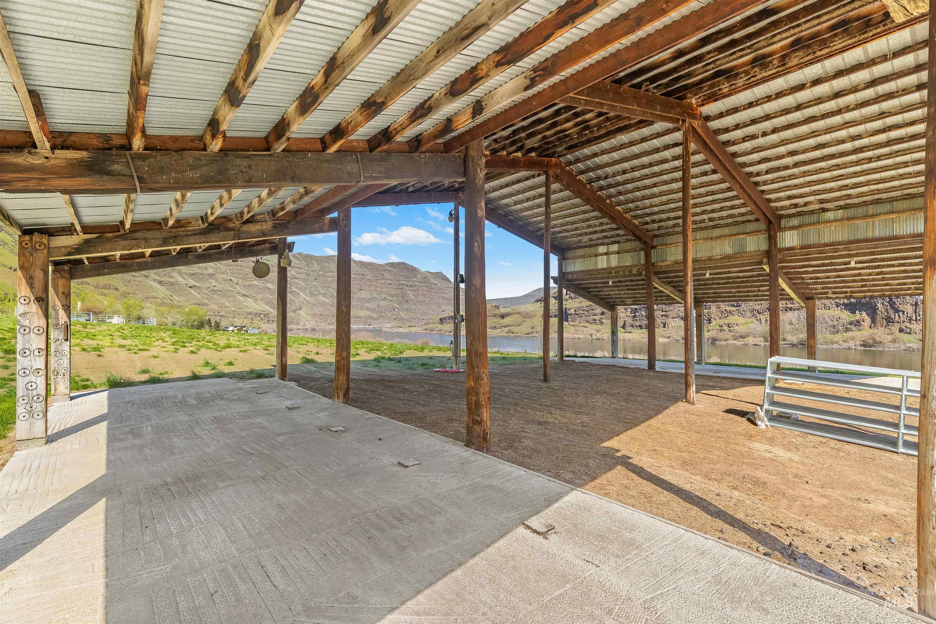 11056 Snake River Road Asotin, WA 99402 - Photo 47 of 50 View of patio / terrace with an outdoor structure, a water and mountain view, and an exterior structure