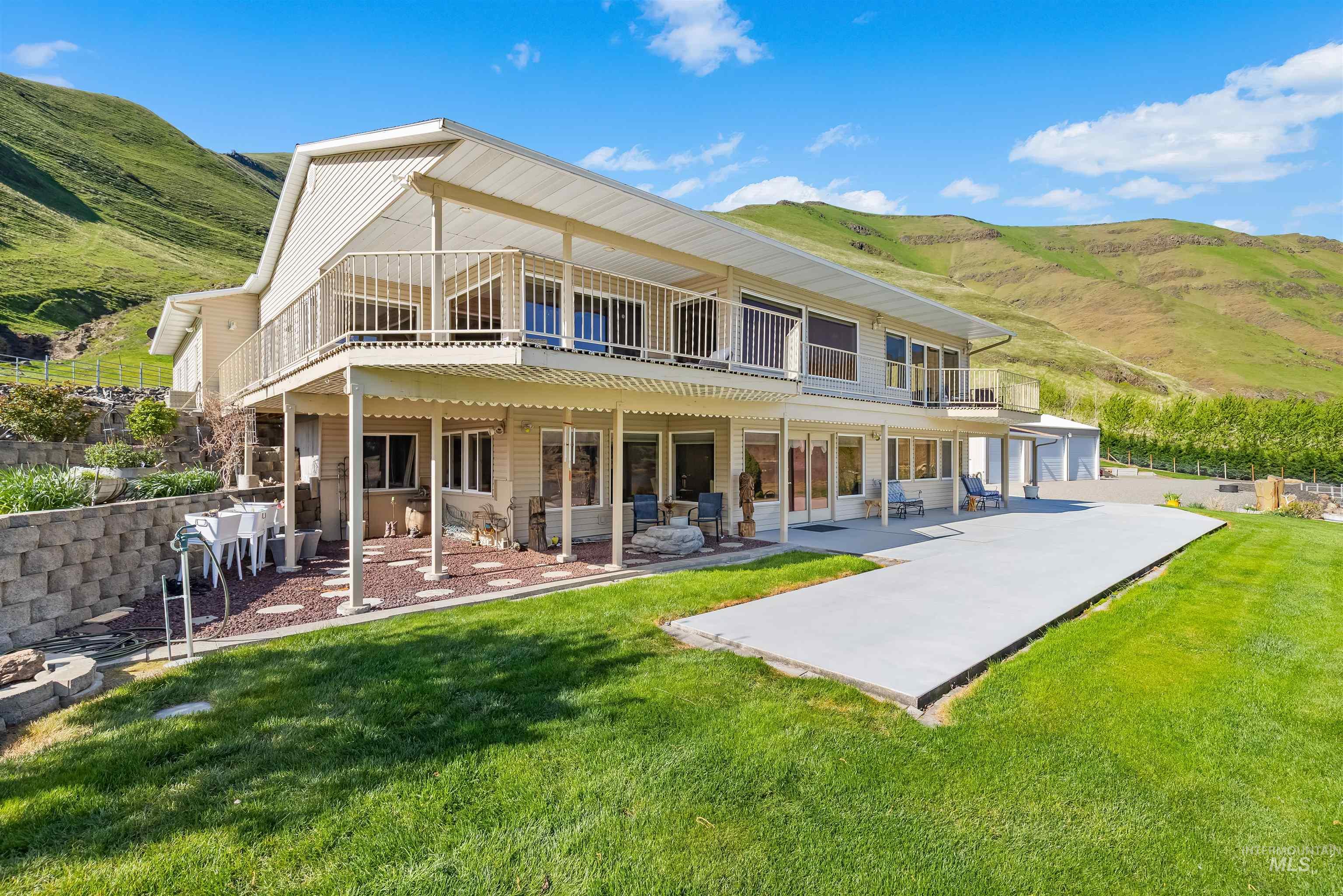 11056 Snake River Road Asotin, WA 99402 - Photo 7 of 50 Back of property with a patio, a mountain view, a balcony, and a lawn