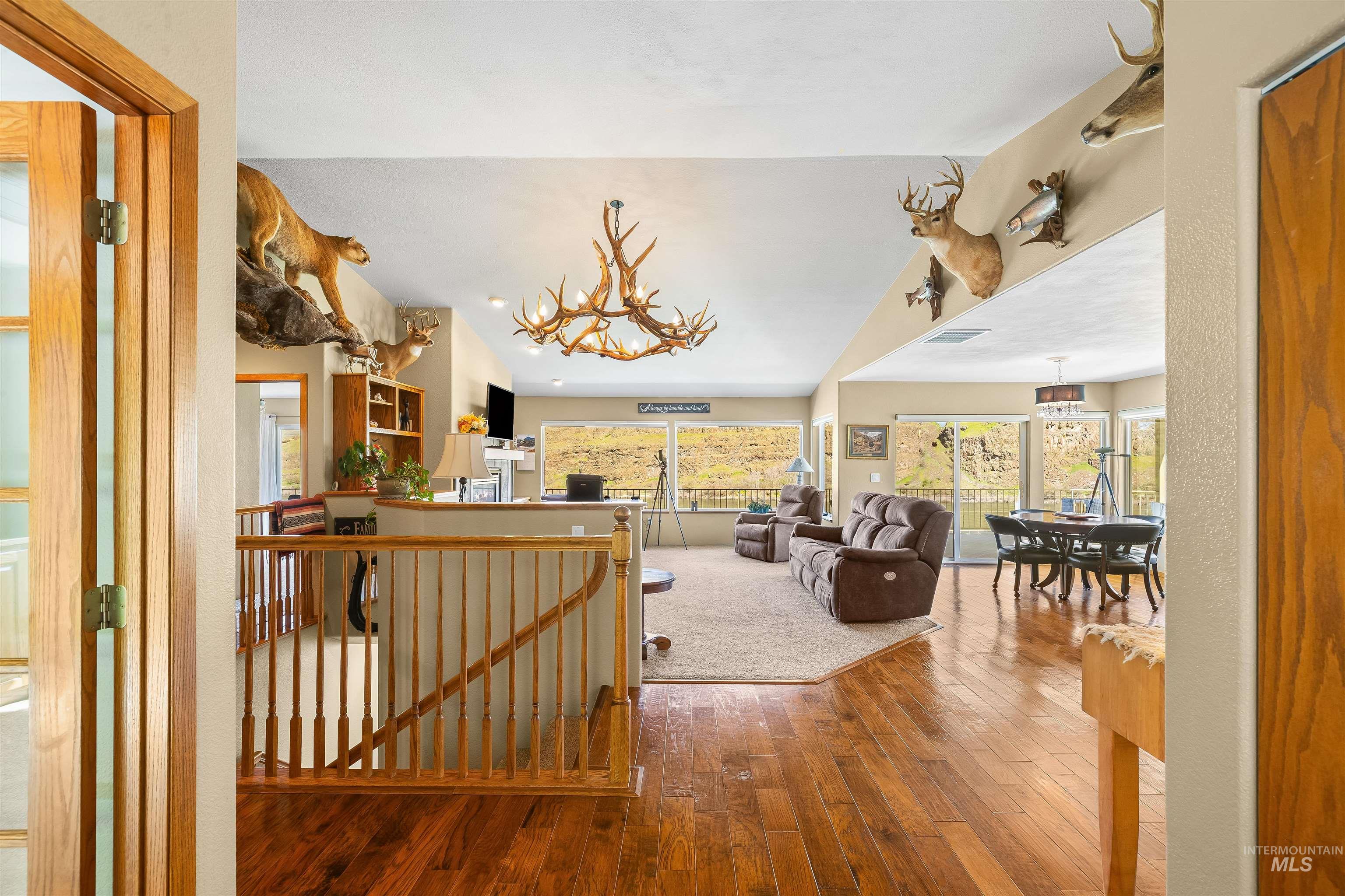11056 Snake River Road Asotin, WA 99402 - Photo 10 of 50 Hall featuring an upstairs landing, hardwood / wood-style floors, and a chandelier
