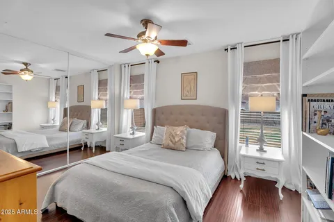 a living room with stainless steel appliances granite countertop a sink a microwave a dining table and chairs with wooden floor