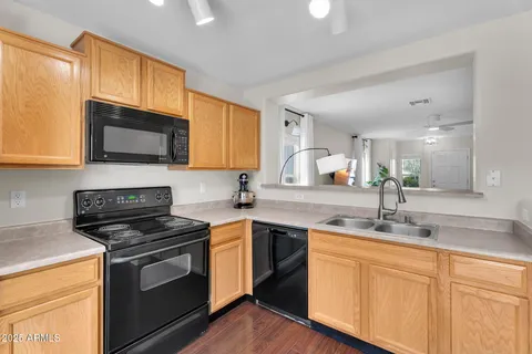 a large kitchen with stainless steel appliances granite countertop a stove a sink and a refrigerator