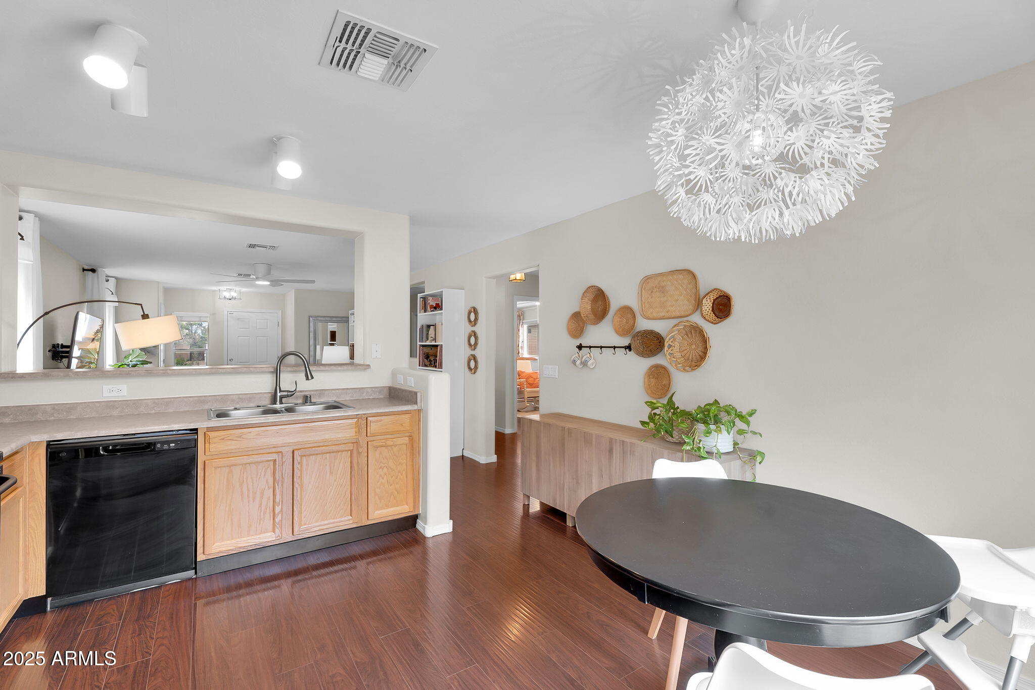 4013 East Superior Road San Tan Valley, AZ 85143 - Photo 9 of 31 a living room with stainless steel appliances granite countertop a sink a microwave a dining table and chairs with wooden floor