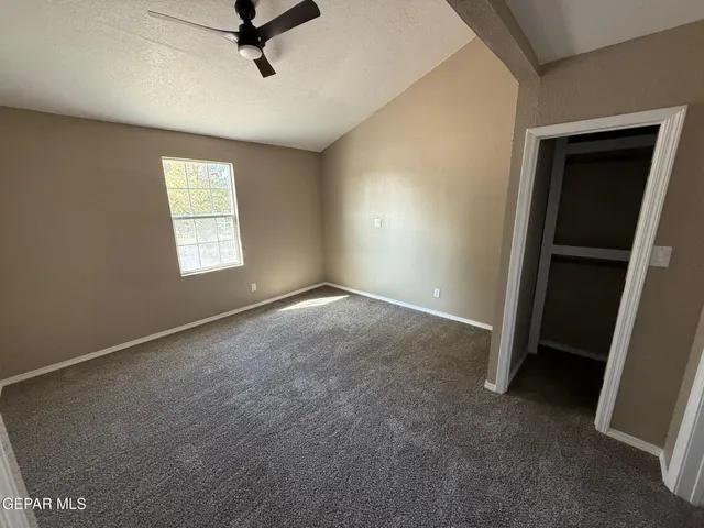 an empty room with windows and closet