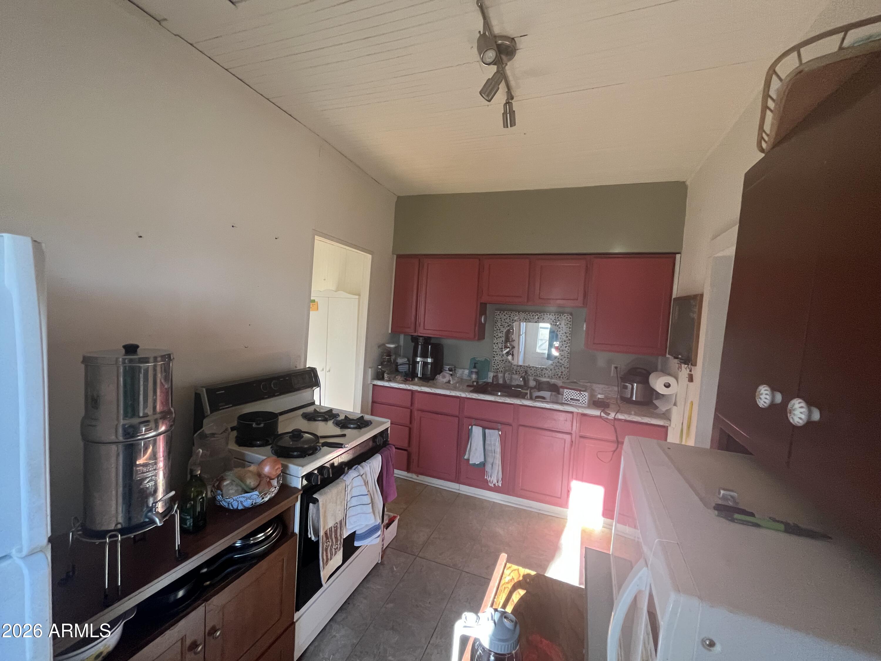 640 West Rocalla Avenue Ajo, AZ 85321 - Photo 16 of 27 a kitchen with stainless steel appliances granite countertop a stove and cabinets