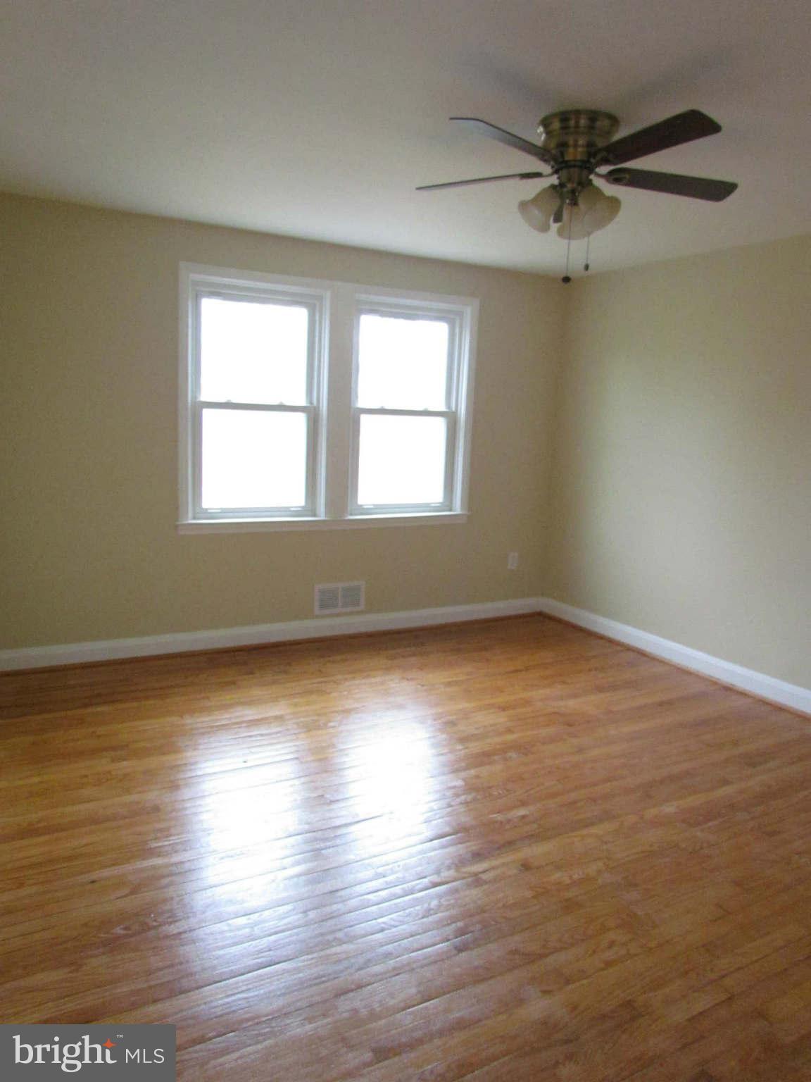 1604 Northbourne Road Baltimore, MD 21239 - Photo 11 of 12 wooden floor in an empty room with a window