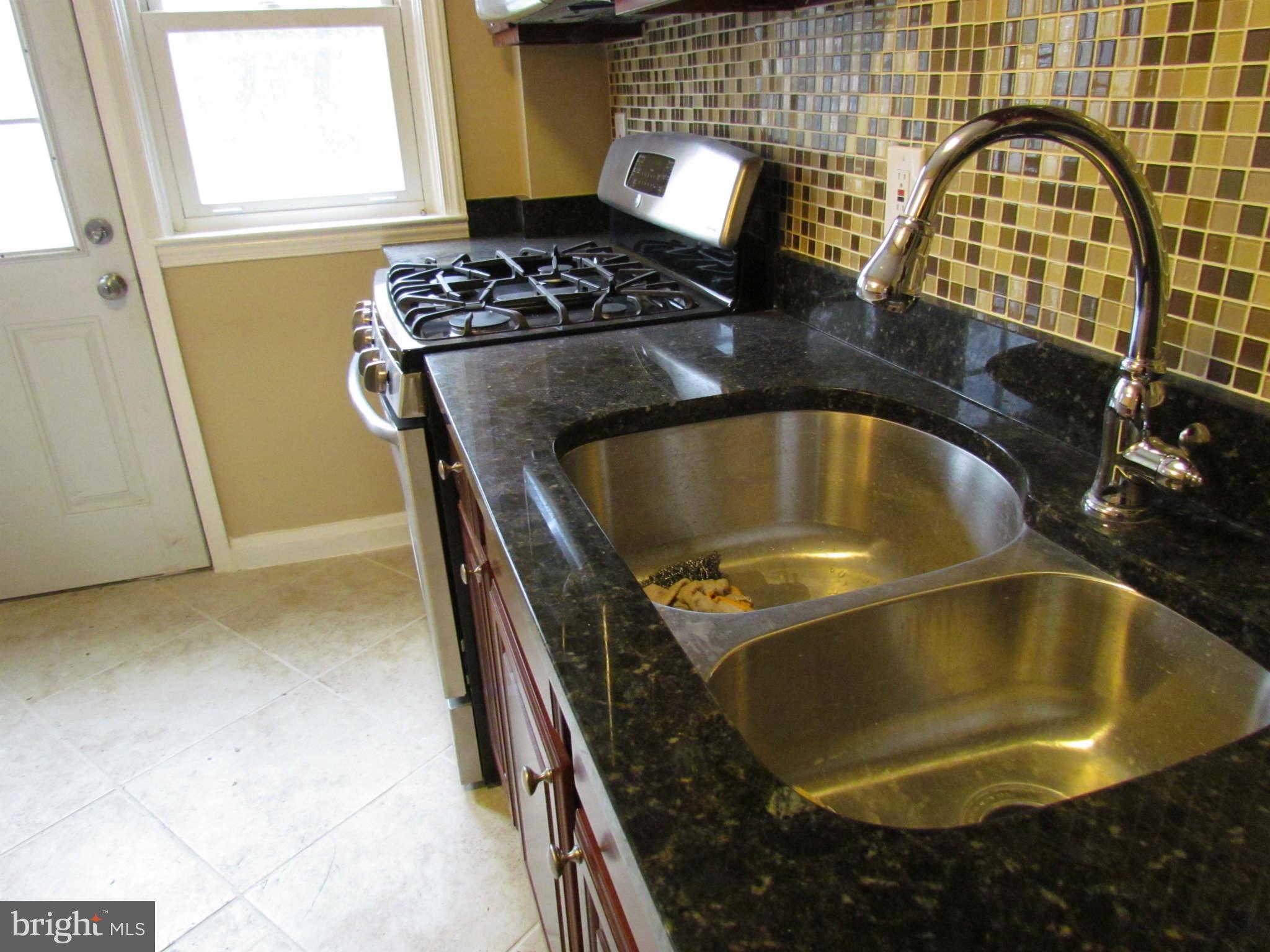 1604 Northbourne Road Baltimore, MD 21239 - Photo 4 of 12 a bathroom with a granite countertop sink and a mirror