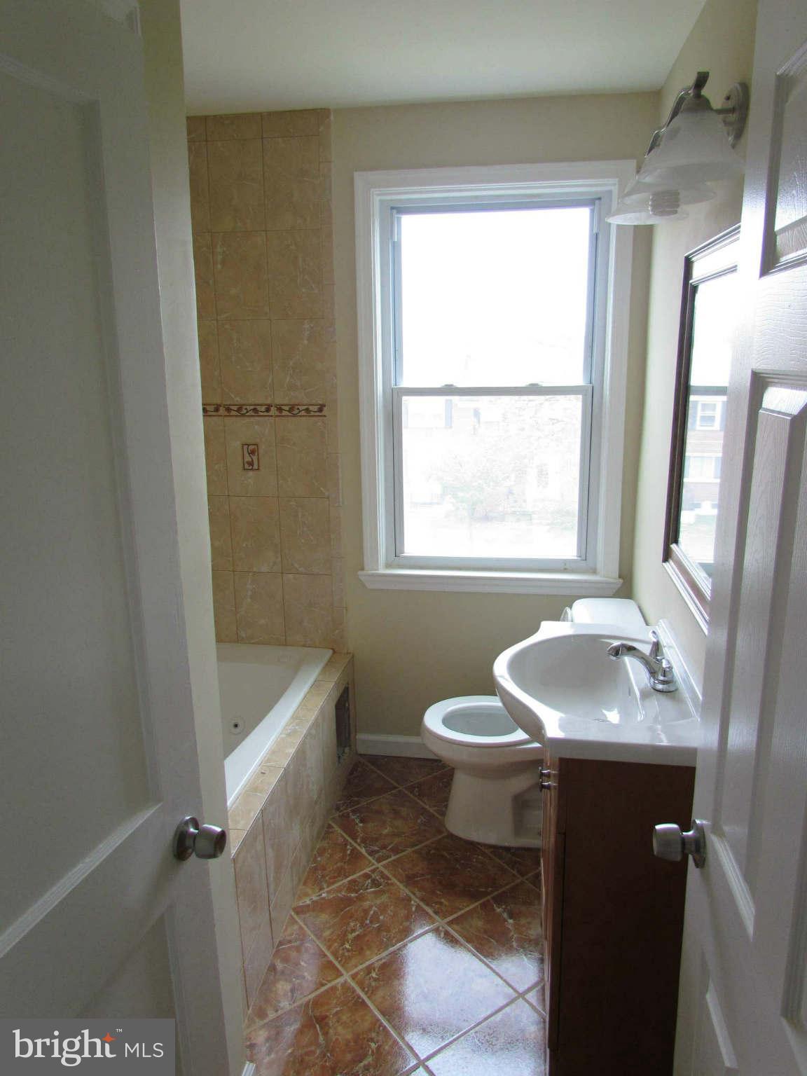 1604 Northbourne Road Baltimore, MD 21239 - Photo 5 of 12 a bathroom with a sink toilet and tub