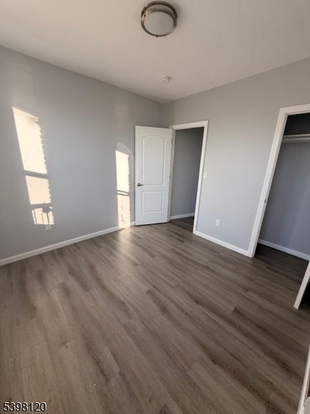 17 Teaneck Road, Unit 3C Ridgefield Park, NJ 07660 - Photo 2 of 9 a view of an empty room with wooden floor and a window