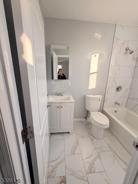 17 Teaneck Road, Unit 3C Ridgefield Park, NJ 07660 - Photo 7 of 9 a bathroom with a toilet sink and mirror with bathtub