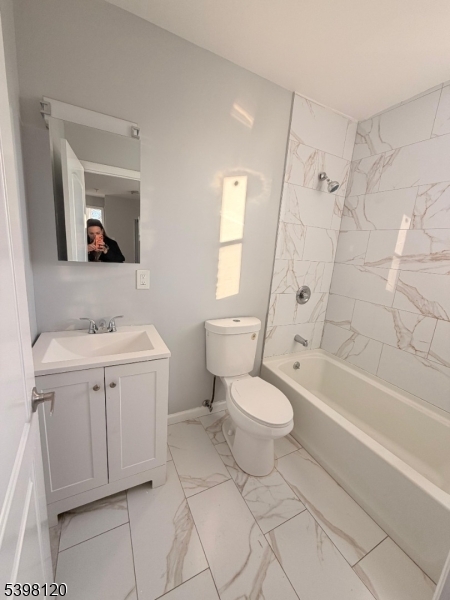 17 Teaneck Road, Unit 3C Ridgefield Park, NJ 07660 - Photo 8 of 9 a bathroom with a toilet sink and mirror
