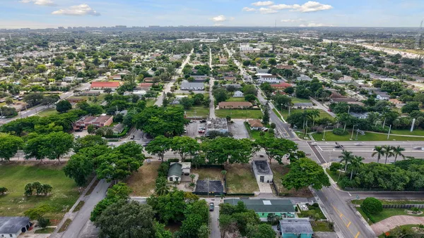 an aerial view of residential houses with outdoor space and river view