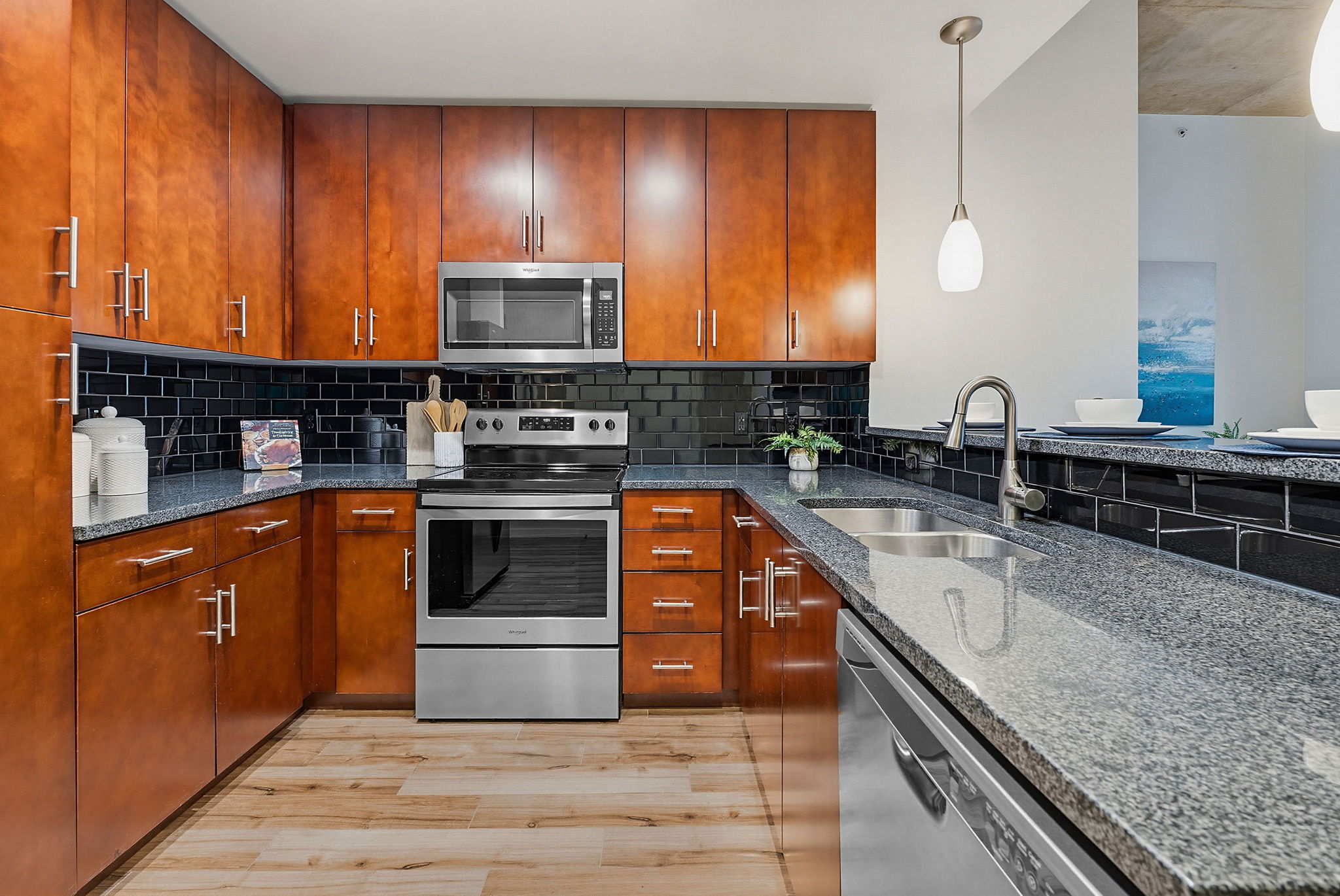360 Nueces Street, Unit 1505 Austin, TX 78701 - Photo 12 of 28 a kitchen with stainless steel appliances granite countertop a stove a sink and a microwave