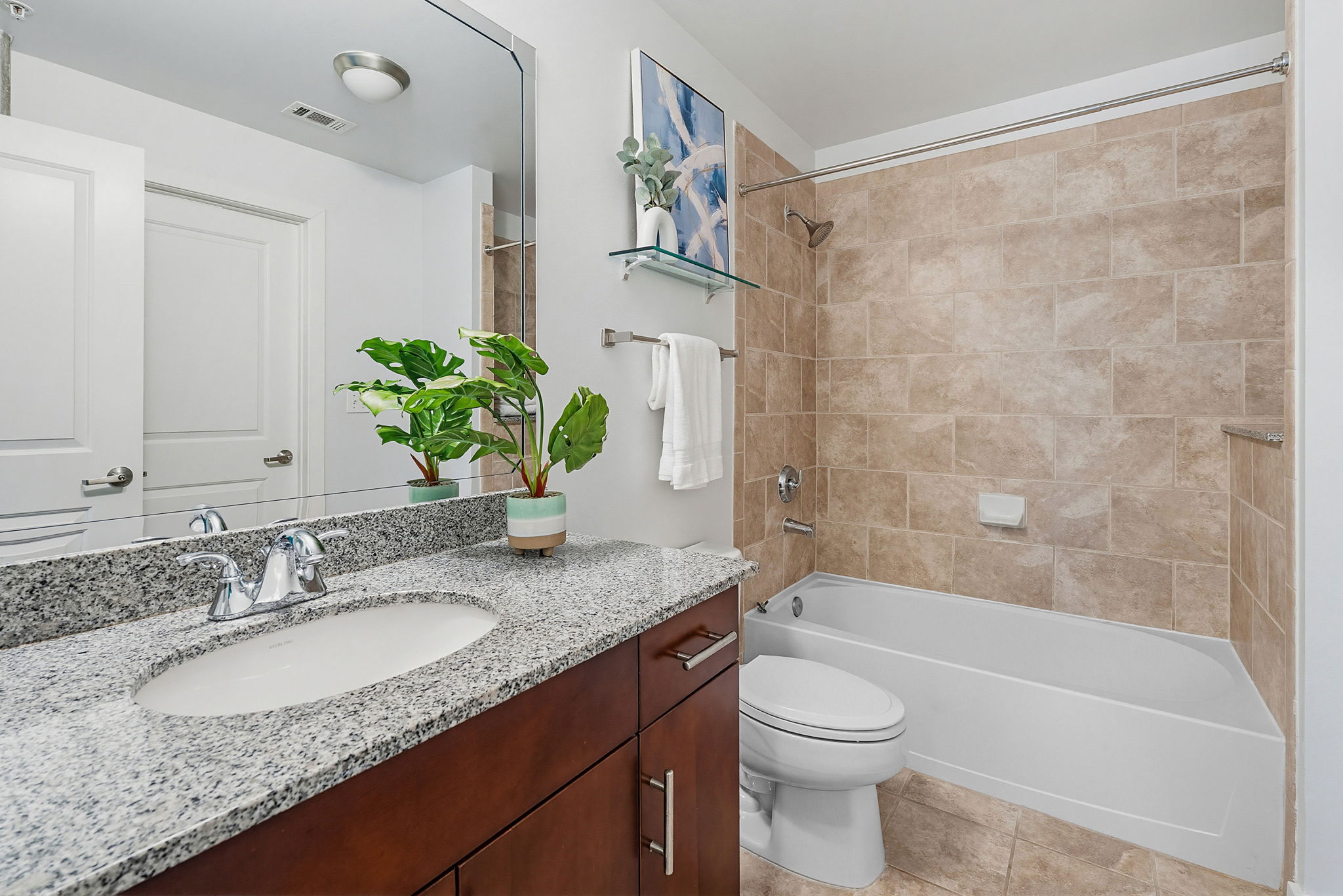 360 Nueces Street, Unit 1505 Austin, TX 78701 - Photo 13 of 28 a bathroom with a granite countertop sink a toilet and shower