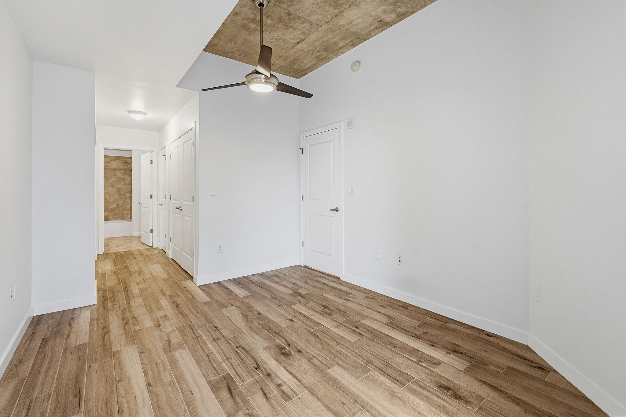 360 Nueces Street, Unit 1505 Austin, TX 78701 - Photo 17 of 28 a view of empty room with wooden floor and fan