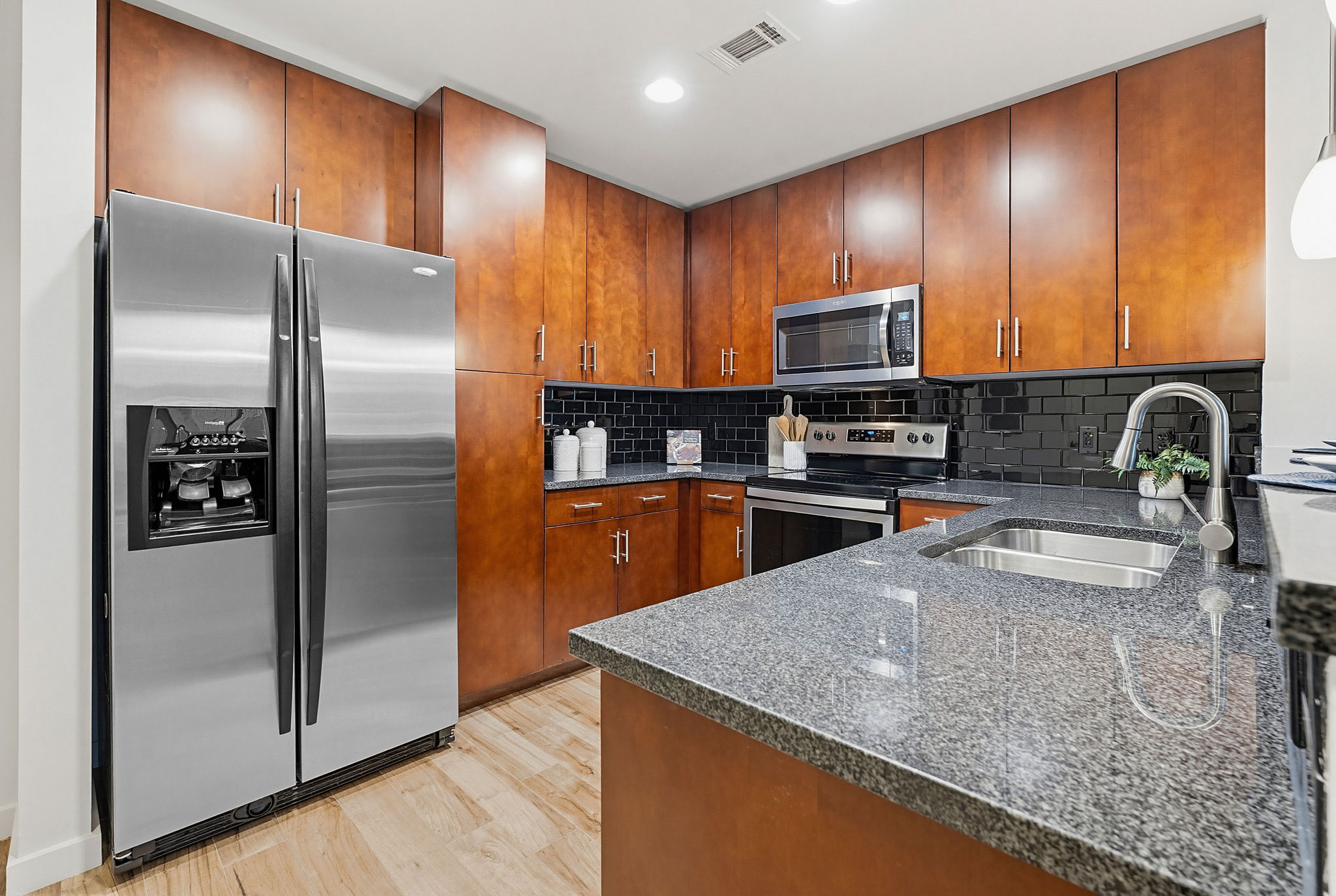 360 Nueces Street, Unit 1505 Austin, TX 78701 - Photo 6 of 28 a kitchen with stainless steel appliances granite countertop a sink a stove and a refrigerator