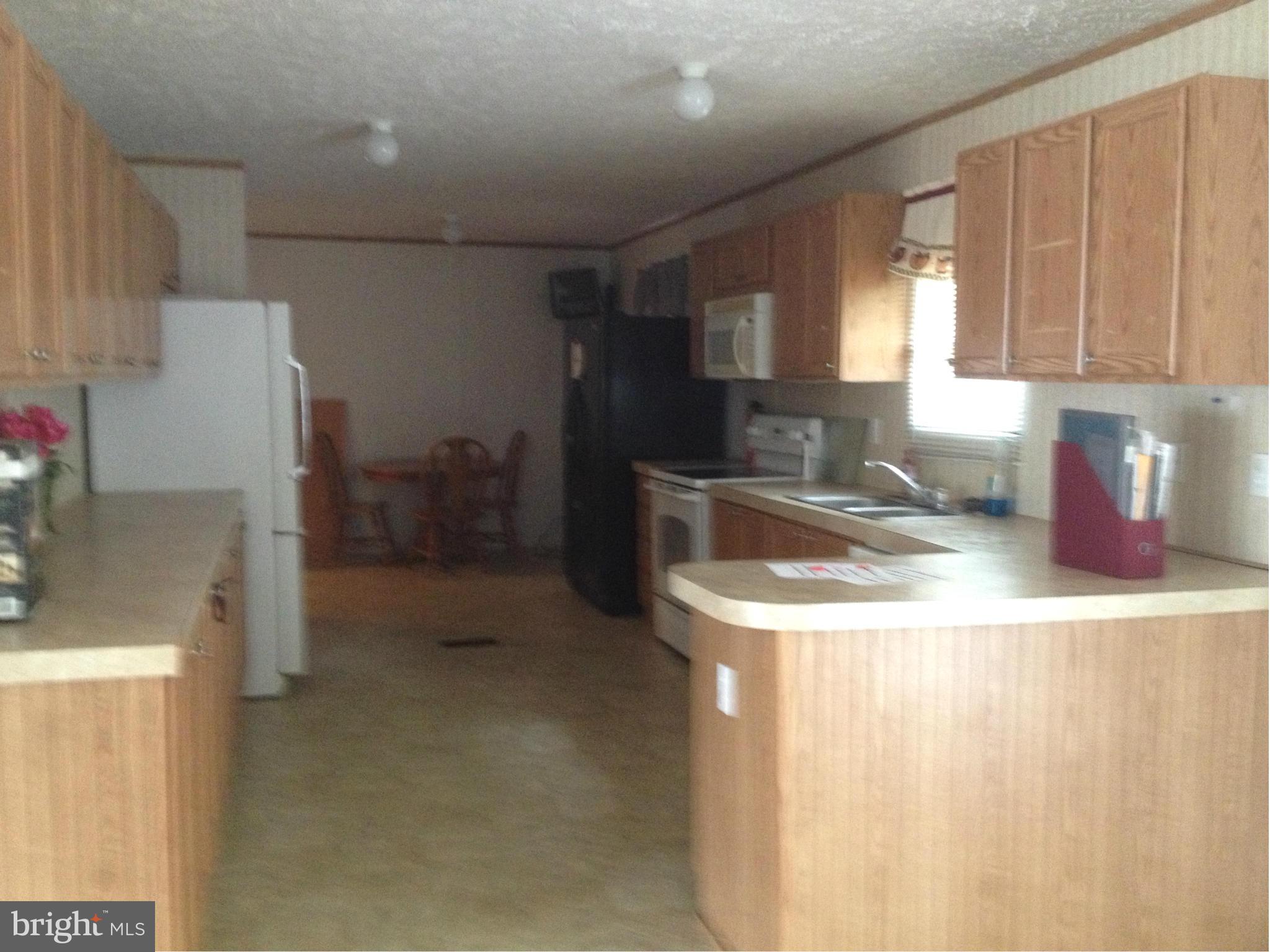 45200 Happyland Road Valley Lee, MD 20692 - Photo 5 of 24 a kitchen with a sink a stove and refrigerator