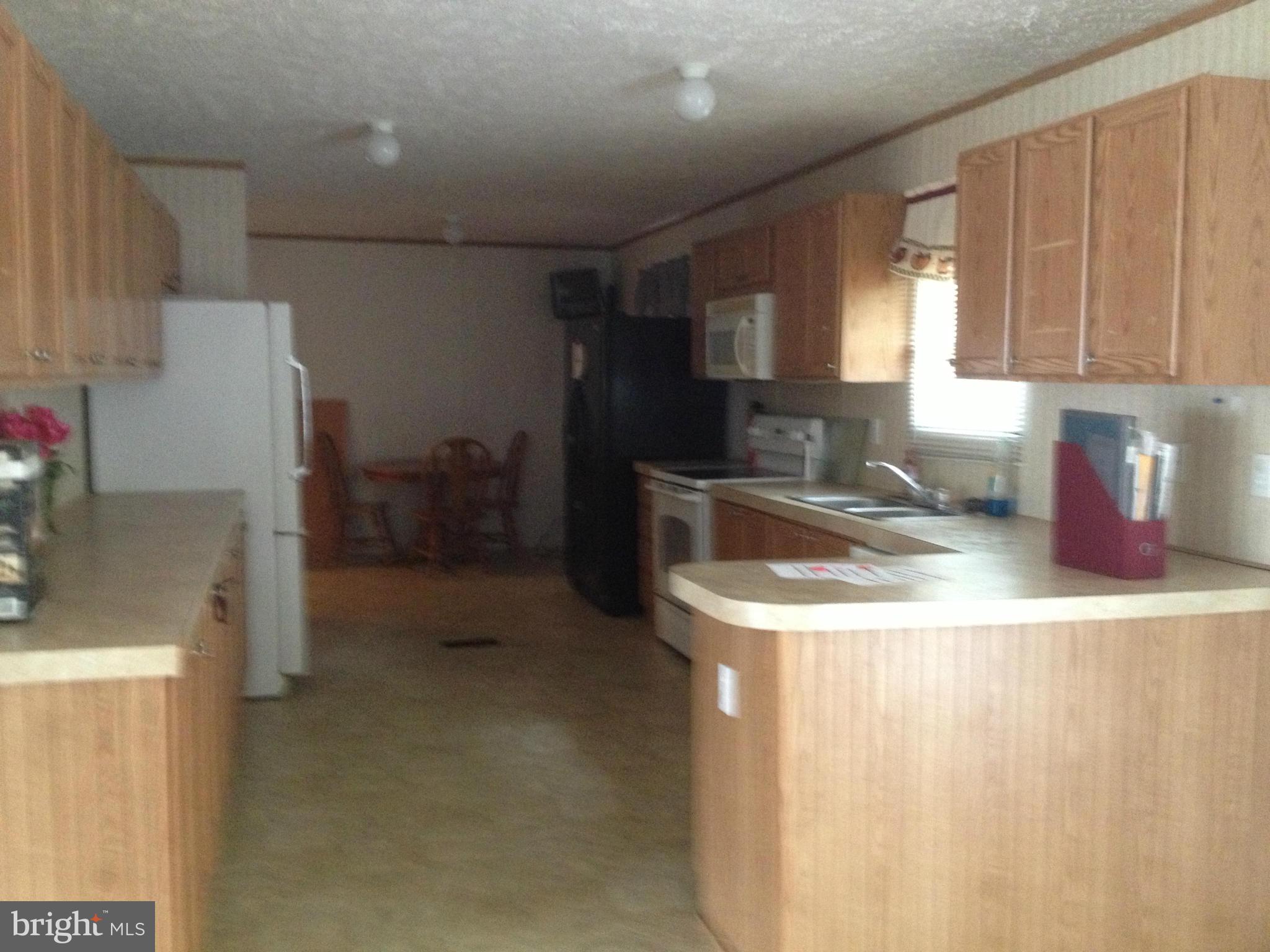 45200 Happyland Road Valley Lee, MD 20692 - Photo 8 of 24 a kitchen with a sink a stove and refrigerator