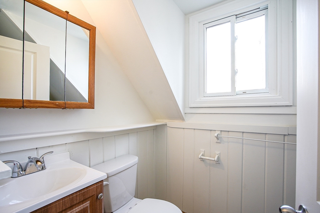 83-85 Wilmont Street, Unit 3 Springfield, MA 01108 - Photo 9 of 12 a bathroom with a sink a toilet and a mirror